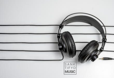Headphones laying flat with the sanktifyd music logo